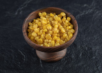 Marinated corn seeds in wooden bowl
