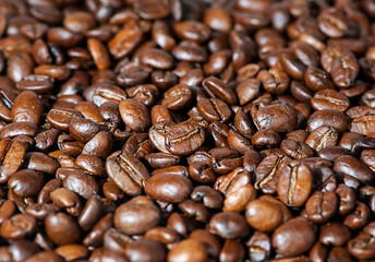 Dark roast coffee beans background, top view.