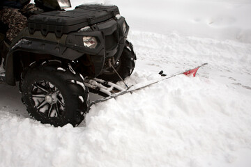 ATV converted into a plow truck. Clearing of snow. cleaning on the street. snow removal machine. cold frosty weather