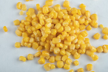 Top view of canned corn seeds on white background