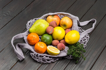 Lychee, pear, apples and lemon in reusable mesh bag