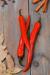 Red chili peppers and spice on a wooden surface