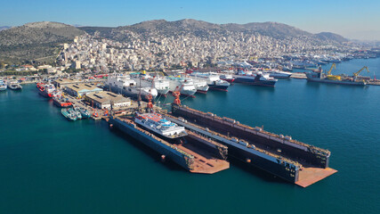 Fototapeta na wymiar Aerial drone photo of small port next to shipyard and ship repair area of Perama next to island of Salamina, Attica, Greece