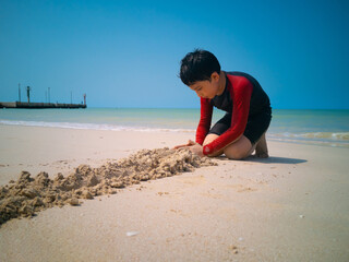 boy playing on the beach