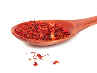 Dried tomato and paprika spice in wooden spoon isolated on the white background