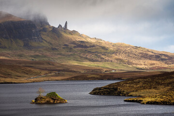 Loch Leathan and Old man of Storr rock formations, Isle of Skye, Scotland. Concept: typical Scottish landscape, tranquility and serenity, particular morphologies.