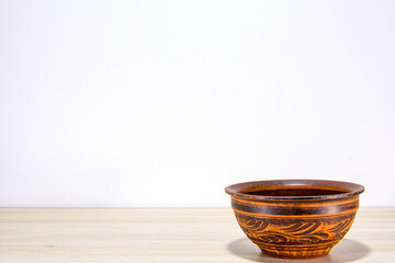 One natural clay plate on the table. Pottery is a way of healthy life and proper nutrition.