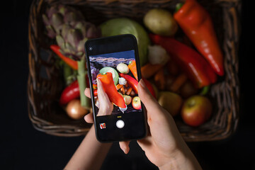 Teen blogger takes a photo on a smartphone for social networks. Diet, technology, health, food, cooking and people.