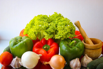 Prepare for a wonderful vegetarian lunch. Washed bell peppers, onions, garlic and lettuce leaves