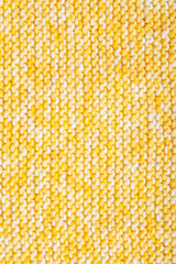 Knitted pattern of yellow yarn, knitted plaid. Needlework, handicrafts, hobbies, creativity, DIY
