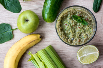 Fresh organic vegetables and fruits with green cocktail. Flat lay for vegan breakfast and healthy food