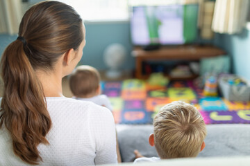 Family mother and children at home watching video TV