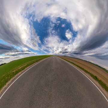 Hemisphere Of The Planet On An Asphalt Road Stretching Beyond The Horizon With Blue Sky And Beautiful Clouds. Spherical Abstract Aerial View. Curvature Of Space.