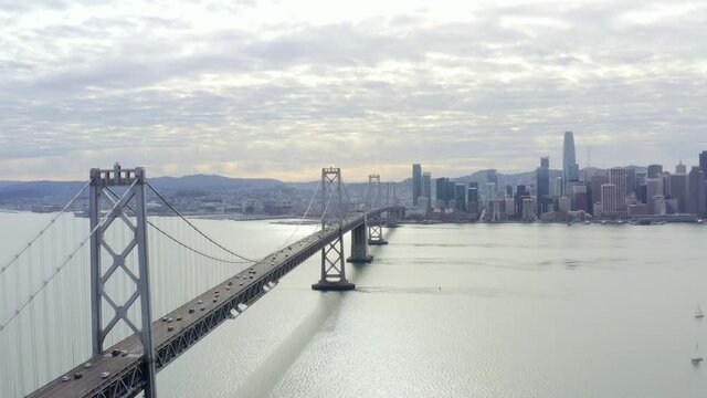 Aerial: cityscape and a bridge by the sea, drone view