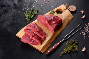 Fresh raw beef meat to make delicious juicy steak with spices and herbs