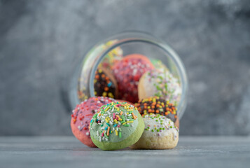 Glass with full of cookies on marble background