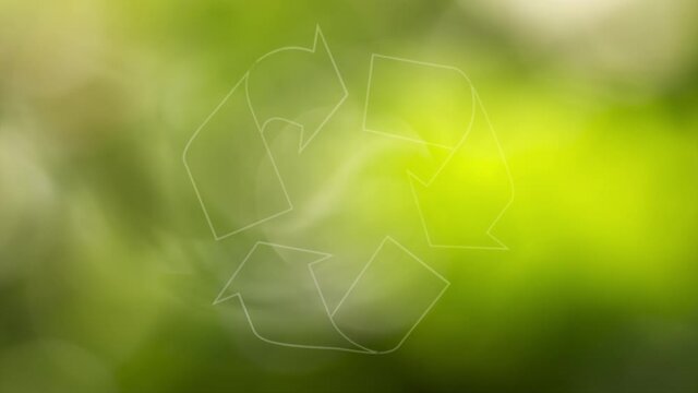 Sunny nature bokeh with recycle sign rotation. Conceptual green clean environment copy space background.