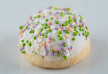 White cookie with candies on white background