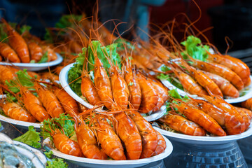 Plates of huge boiled shrimp at the street food market