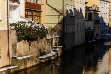 Kampa Island under Charles Bridge and small river Devil, water channel Certovka, Prague Venice under snow in winter day, Mala Strana or Lesser Town district, Prague, Czech Republic