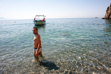 Handsome guys who reached the beach of 'Buondormire' with a motorboat, Palinuro, Italy.