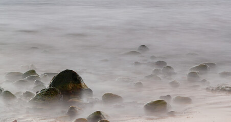 green moss and mist. misty appearence on the seaside rock with misty dreamy feeling effect of the long exposure.