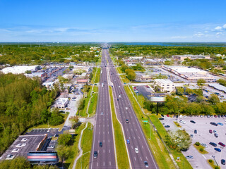 Highway or Freeway road. Low traffic on the way. Wide road with many lanes. Highway for any transportation. Road for cars and truck. The Best US American roads. City panorama landscape. Aerial view.