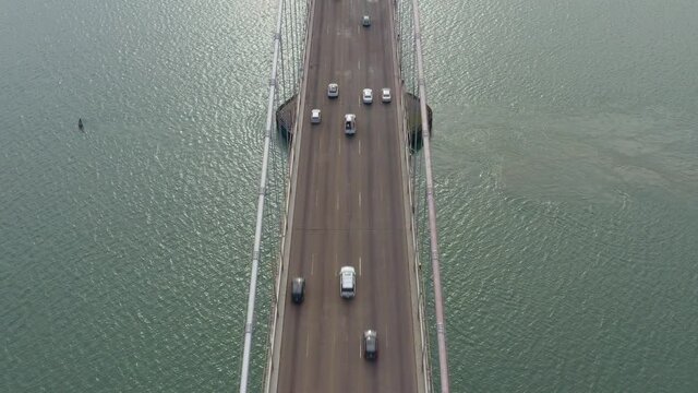 Aerial: traffic passing through the bridge, drone view