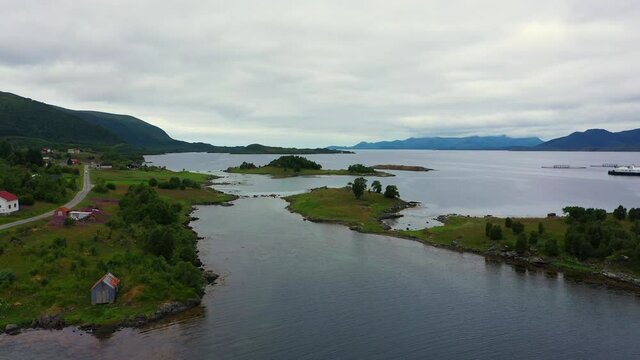 Aerial view of houses and islands, outside the coast of Vesteralen, Norway - rising, drone shot