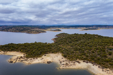 Drone aerial view of Idanha Dam Marechal Carmona landscape with beautiful blue lake water, in Portugal