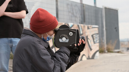 Filmmaker girl filming in the skate park