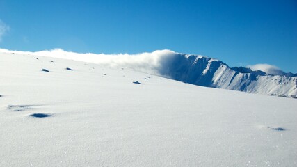 top of the mountain full virgin snow cloud clear sky