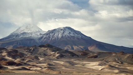 High snowed mountain twin volcano in atacama desert chile