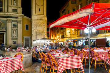 The lively Place Rossetti square late at night as tourists and French enjoy an Italian sidewalk...