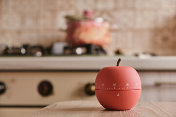modern kitchen timer apple shaped on the background of the kitchen