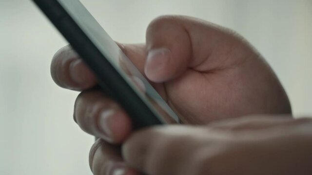 Man using smartphone scrolling through social media, doing swiping, scrolling gestures.
