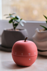 Modern apple shaped timer next to windows