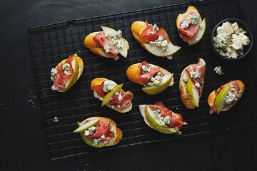 Small appetizers with prosciutto on board