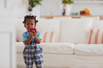 cute african american baby girl playing toys at home