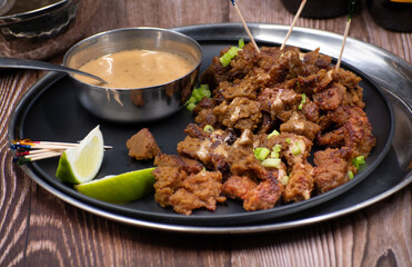 Vegan Satay seitan pieces served with peanut sauce