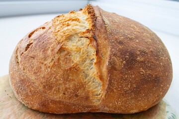 loaf of bread on table, crispy crust