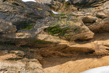 Stone texture, background of natural rock, mountain range close-up, stone boulders overgrown with moss