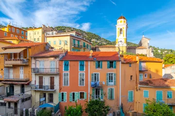 Photo sur Plexiglas Villefranche-sur-Mer, Côte d’Azur Colorful village of Villefranche-Sur-Mer, France and the yellow church clock tower of Saint Michel Church in the seaside town on the French Riviera.