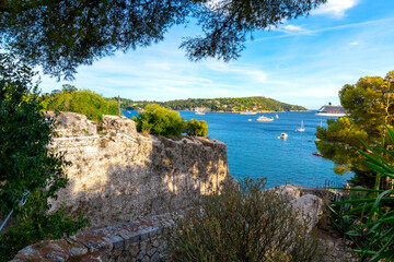 View from the castle fort at Villefranche-Sur-Mer, France, of the Mediterranean sea, hillls and luxury yachts in the water.