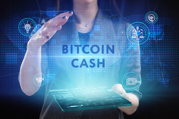 Business, Technology, Internet and network concept. Young businessman working on a virtual screen of the future and sees the inscription: Bitcoin cash