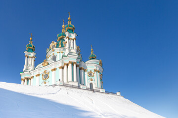 Kyiv, Ukraine. View of St. Andrew's Church on the snow-capped St. Andrew's Hill. Stauropegia of the...