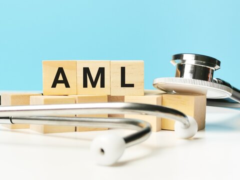 Phrase AML written on wooden cubes with stethoscope. Medical and health concept.