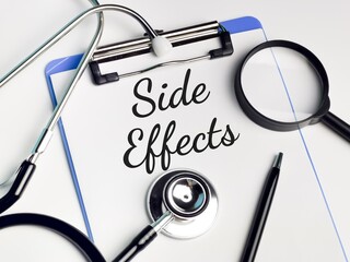 Medical and health concept. Phrase SIDE EFFECT written on paper clipboard with...