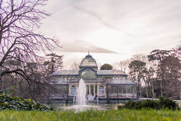 Fototapeta premium Madrid, Spain; March 7, 2019. Crystal Palace in Retiro Park with its fountain and lake in front.