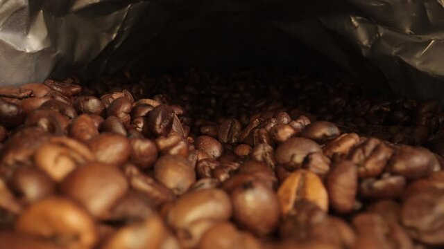 Freshly roasted Coffee Beans - sliding macro shot